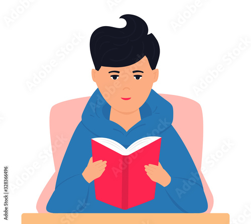 A boy sits in a chair and reads a book. Schoolchild preparing for the exam. Literature fans. Love reading.