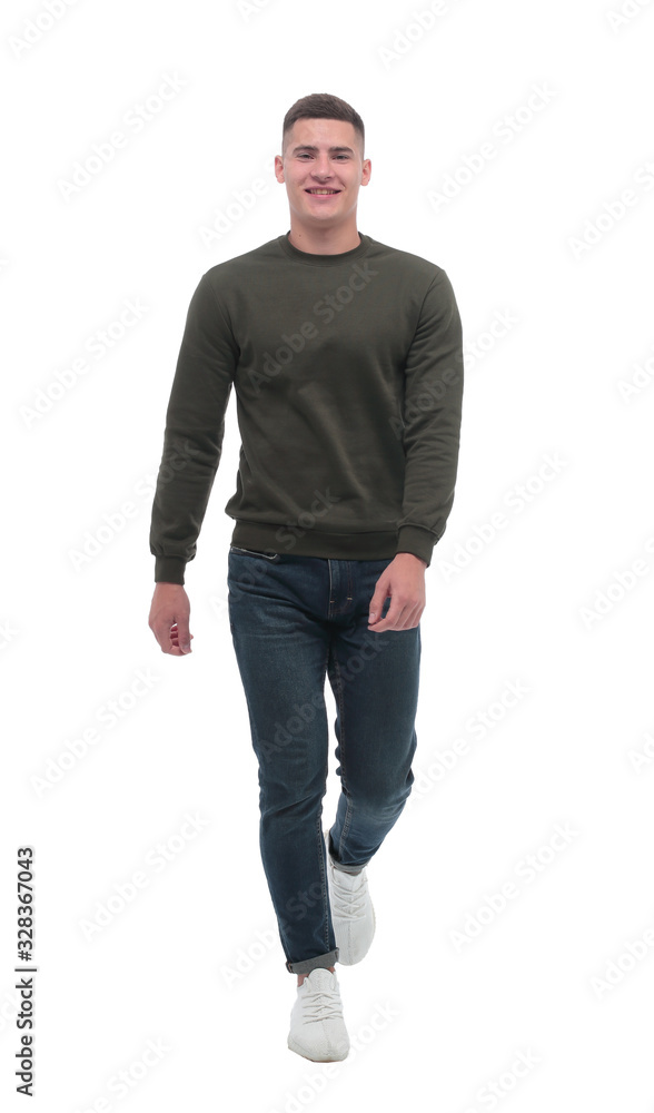 in full growth. a confident man in jeans walks forward . in full growth. a confident man in jeans walks forward .