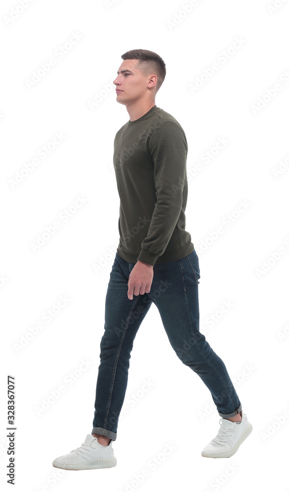 in full growth. a confident man in jeans walks forward . in full growth. a confident man in jeans walks forward .