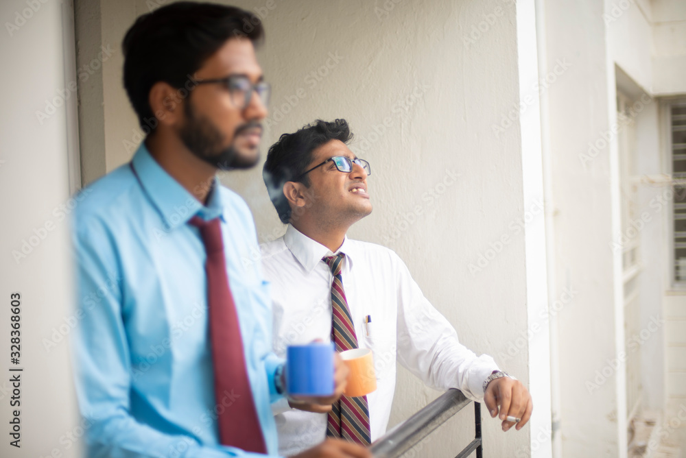 Corporate meetings with coffee/tea between young and energetic Indian Bengali bosses/officers/managers and secretary at balcony of the office building regarding a project. Indian corporate lifestyle Corporate meetings with coffee/tea between young and energetic Indian Bengali bosses/officers/managers and secretary at balcony of the office building regarding a project. Indian corporate lifestyle