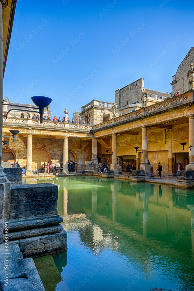 Naklejka premium BATH, ENGLAND - March 27, 2019 - The Roman baths are Bath's major tourist attraction and receive more than 1.3 million tourists every year. The city of Bath is a UNESCO World Heritage Site.