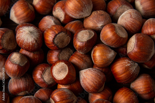 Lot of hazelnuts in shells, close up. Flat lay. 