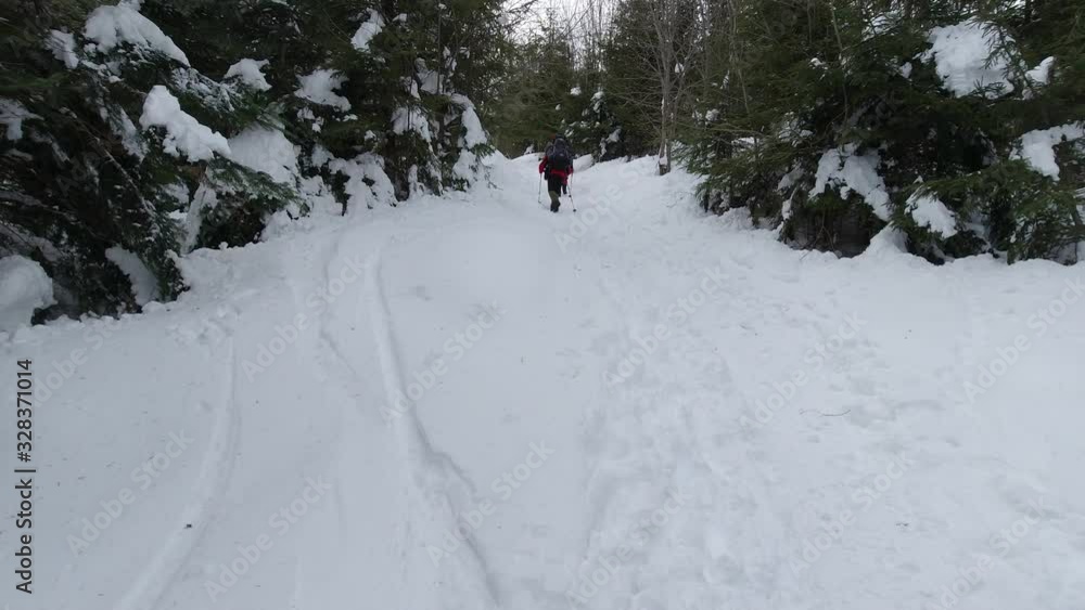 Tourists with backpacks climb the mountain on a winter day. Tourists with backpacks climb the mountain on a winter day.