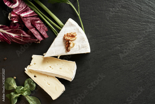 Obraz na plátne Delicious brie cheese on black background