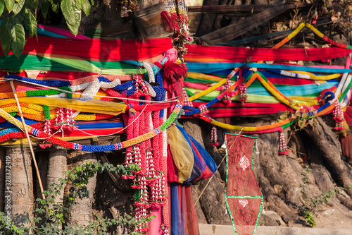 The usual offerings consist of colored ribbons trees surrounded by colored scarves (khatas) symbolize kindness, compassion and luck in Bangkok