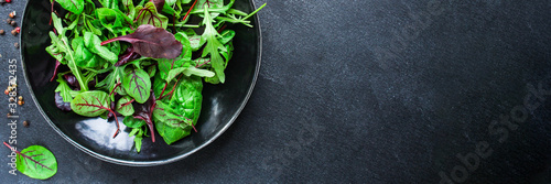 Healthy salad, leaves mix salad (mix micro greens, juicy snack) keto or paleo menu recipe. food background, copy space