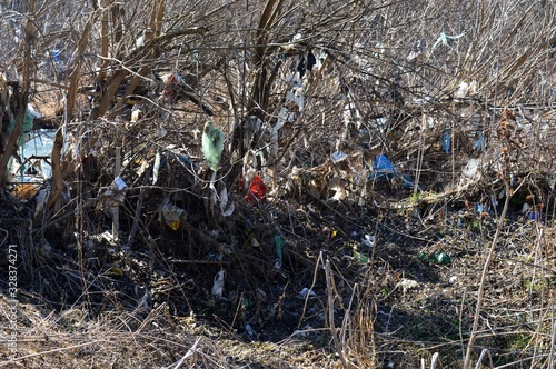 Wallpaper Mural plastic bags and waste on tree branches by the river Torontodigital.ca