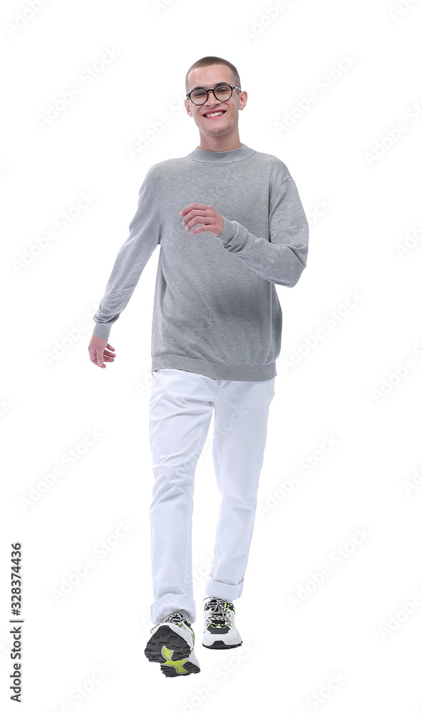 Fototapeta premium in full growth. smiling youngster in glasses goes forward