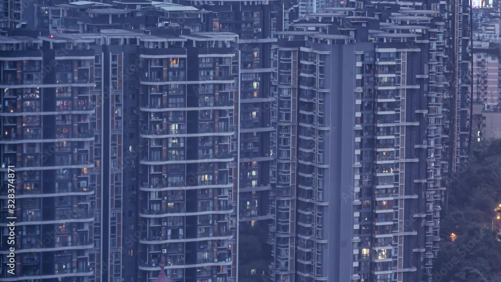 Day to night to day timelapse of dense apartments. Time lapse of modern lifestyle in Chinese city with crowded dense residential buildings. Night to morning transition overnight of rows of flats. Day to night to day timelapse of dense apartments. Time lapse of modern lifestyle in Chinese city with crowded dense residential buildings. Night to morning transition overnight of rows of flats.