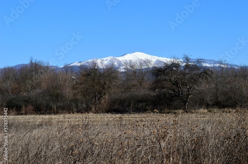 mountain peak under snow in spring