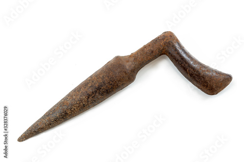 old iron dibber for planting bulbs, seedlings and seeds ,old rusty tool, on white photo
