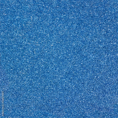 Surface texture with blue sparkles. Seamless festive background. Dark backdrop