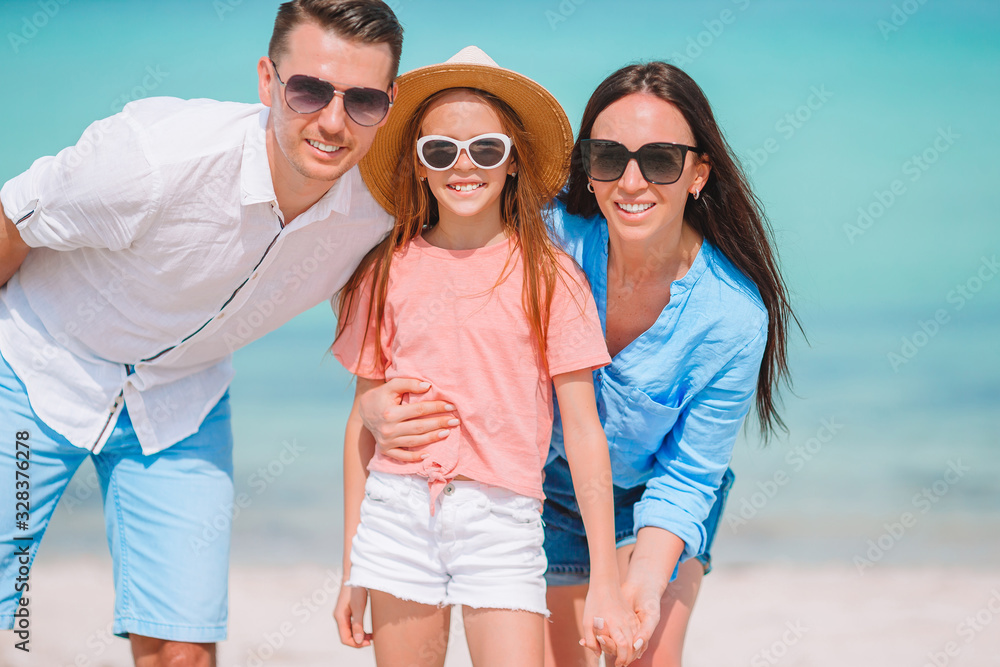 Happy family on the beach during summer vacation