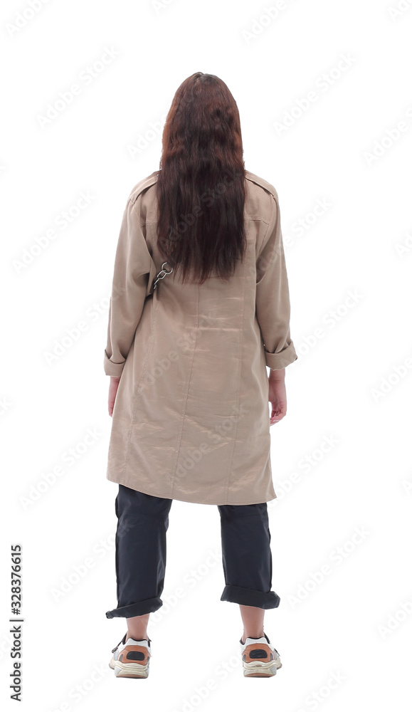 rear view. young woman in autumn coat looking at white blank screen. rear view. young woman in autumn coat looking at white blank screen.