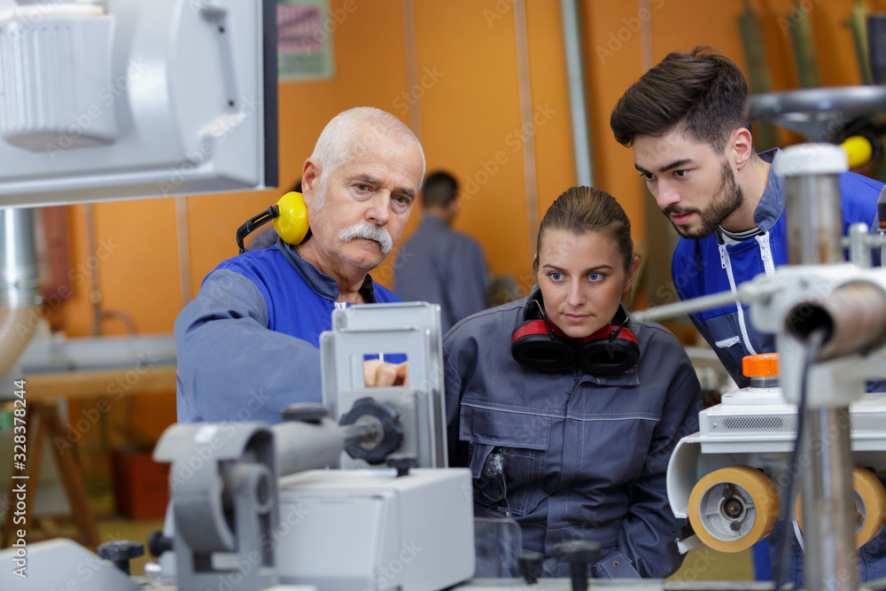 man and woman with machine cnc man and woman with machine cnc