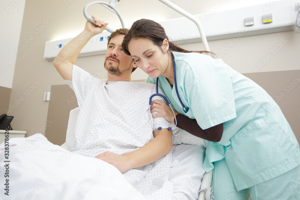 helping male patient out of bed Stock Photo Adobe Stock