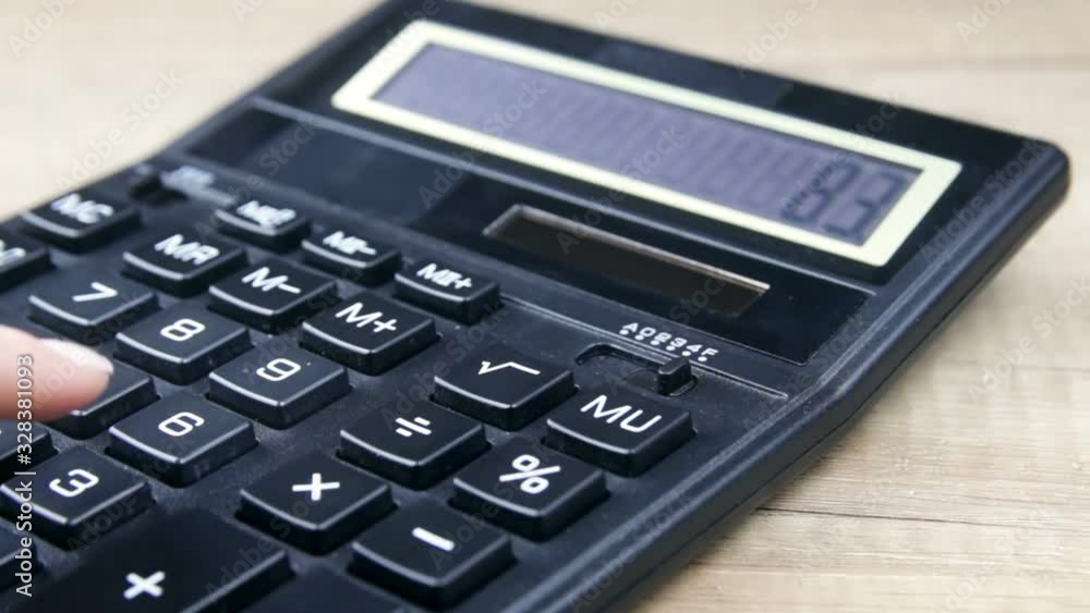 Closeup of a business woman using calculator in office. Savings, finances and economy concept Closeup of a business woman using calculator in office. Savings, finances and economy concept