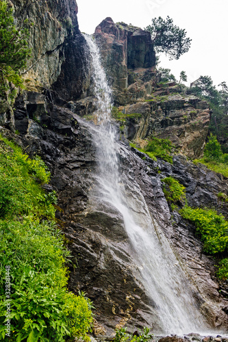 waterfall flowing down a steep cliff in the mountains