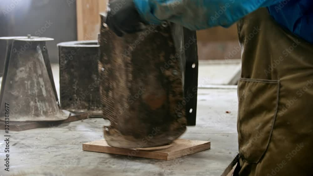 Concrete industry - worker putting the figure out from the form Concrete industry - worker putting the figure out from the form