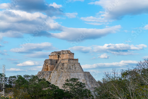 Pyramid of the Magician emerges from forest, rear side, Uxmal, Mexico
