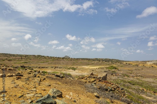Natural beauty of Aruba. North coast. Off-road Aruba. Amazing stone desert landscape and blue sky with white clouds.