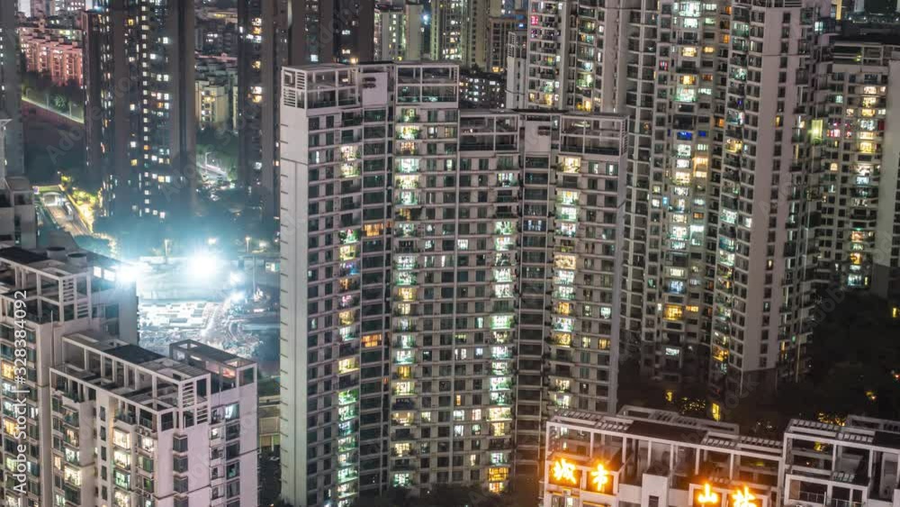 Night time lapse of apartments and construction. Timelapse of residential flats windows lighting up and turning off overnight in Shenzhen, China. Modern life in crowded massive apartment buildings. Night time lapse of apartments and construction. Timelapse of residential flats windows lighting up and turning off overnight in Shenzhen, China. Modern life in crowded massive apartment buildings.