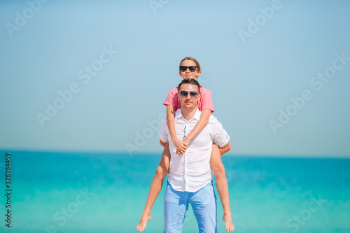 Little girl and happy dad having fun during beach vacation © travnikovstudio