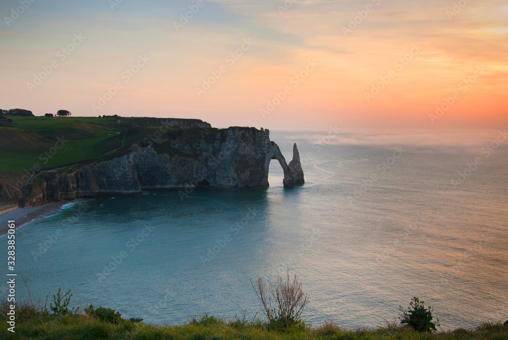 Landscape of the city of Etretat , the cliffs and Bay at sunset. Etretat, France