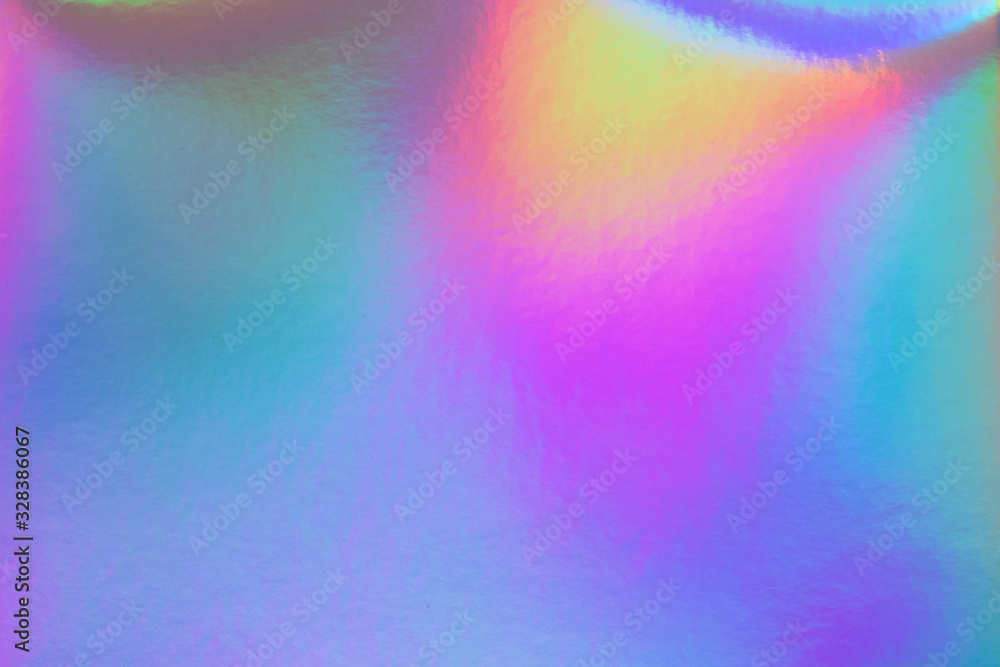 Abstract trendy rainbow holographic background in 80s style. Blurred texture in violet, pink and mint bright neon colors.