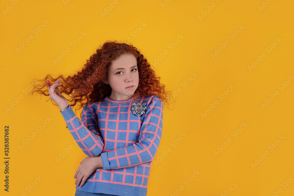Beautiful red-haired girl on a yellow background Beautiful red-haired girl on a yellow background