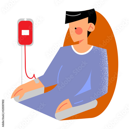 Young man sitting and giving blood as donor