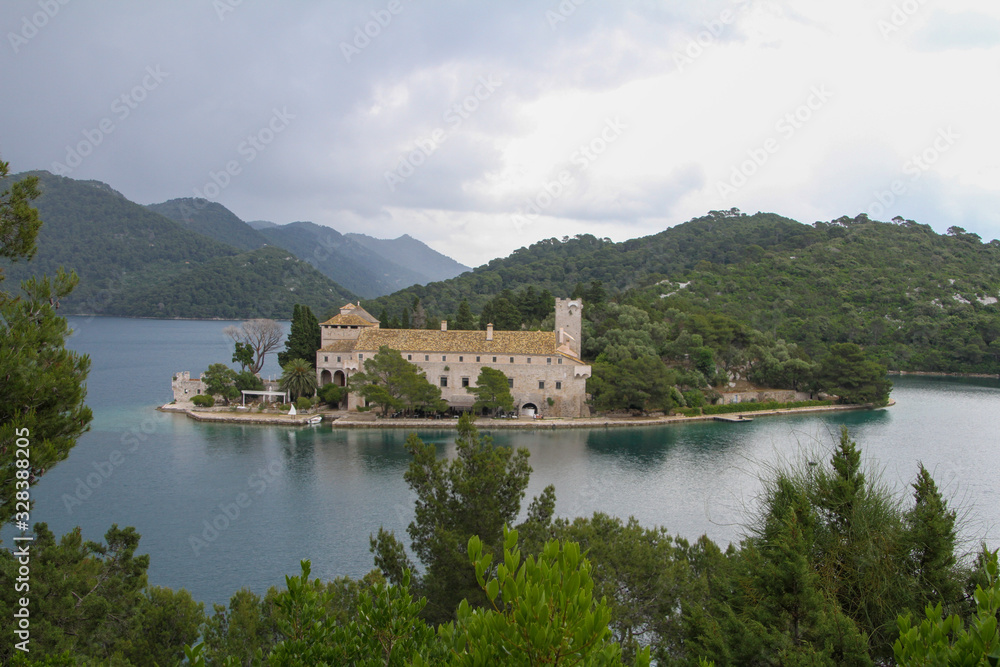 an abandoned monastery on an island on the lake