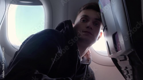 the guy got seasick on the plane.the guy's scared on the plane photo