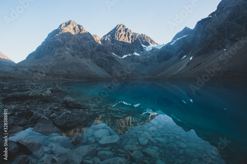 Beautiful wide view of Blavatnet - the norwegian glacial Blue Lake in Northern Norway, views of the Lyngen Alps