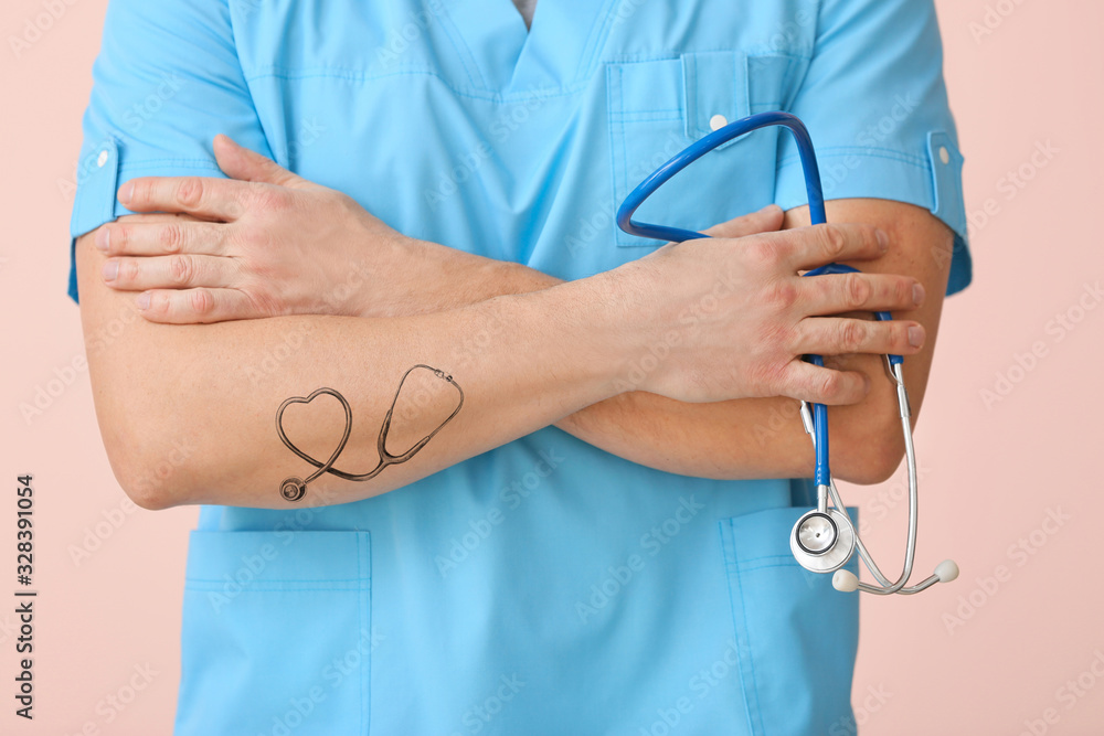 Male doctor with tattoo of stethoscope on arm, closeup Male doctor with tattoo of stethoscope on arm, closeup