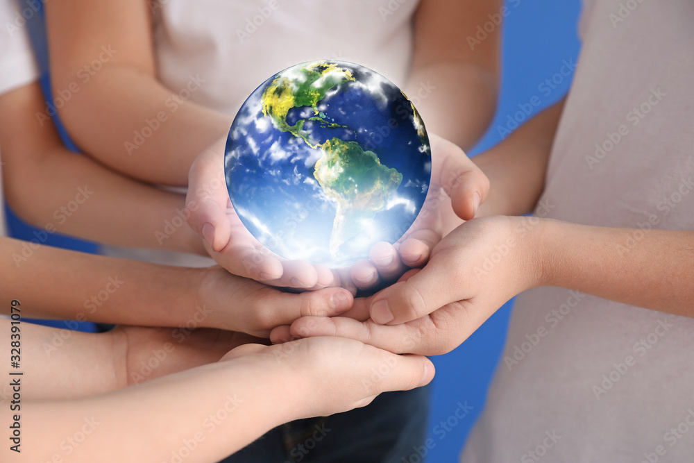 Hands of little children holding planet Earth, closeup Hands of little children holding planet Earth, closeup