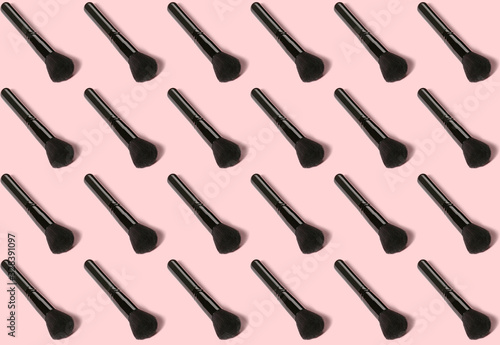 Many makeup brushes on color background