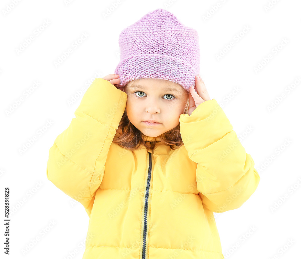 Cute little girl in winter clothes on light background Cute little girl in winter clothes on light background