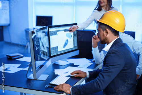 Engineers working in office...