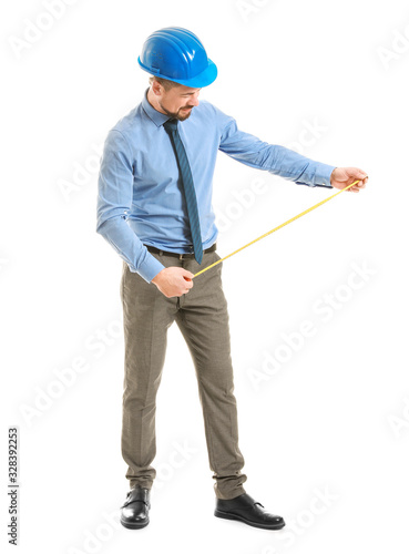 Male engineer with tape measure on white background