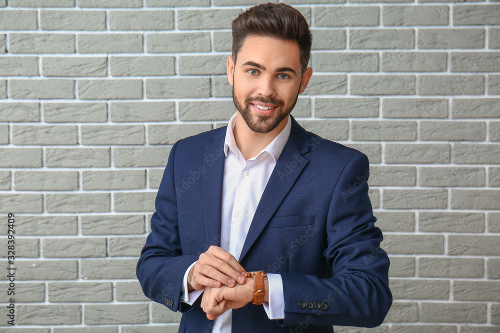 Portrait of handsome businessman on brick background Portrait of handsome businessman on brick background
