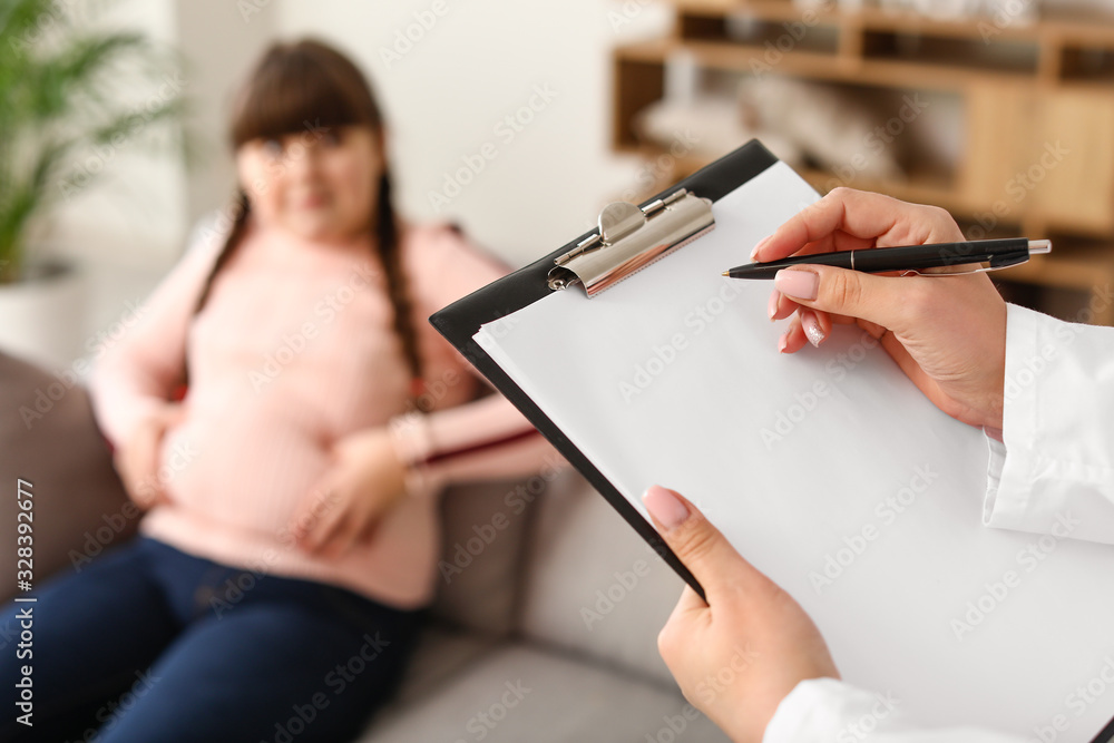 Doctor examining fat girl in clinic, closeup Doctor examining fat girl in clinic, closeup