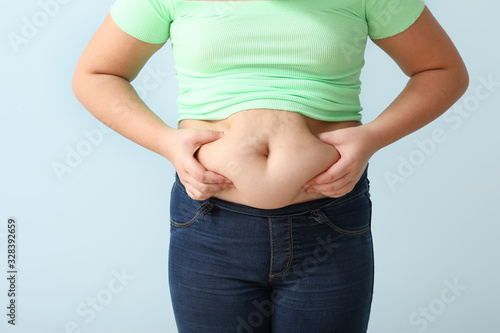 Overweight girl on color background