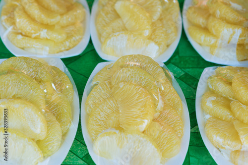 Peeled and packed pomelo on street market.