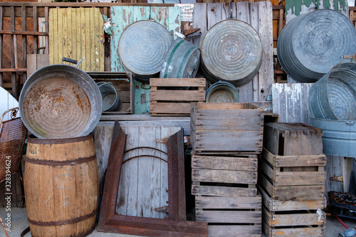 Collection of old barrels, washtubs etc on a wall. photo