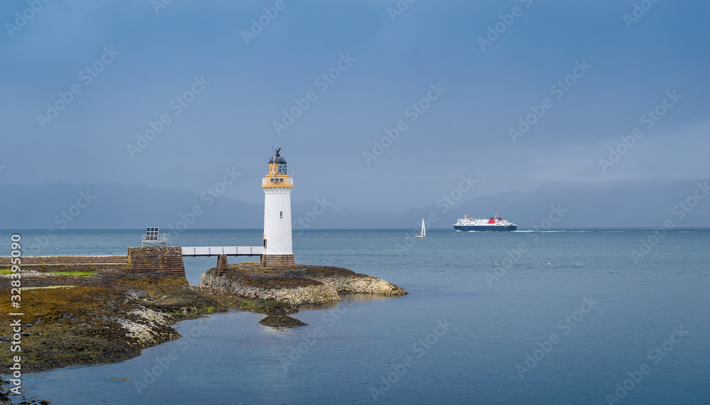Sea traffic and lighthouse at the north of Mull island, Scotland.