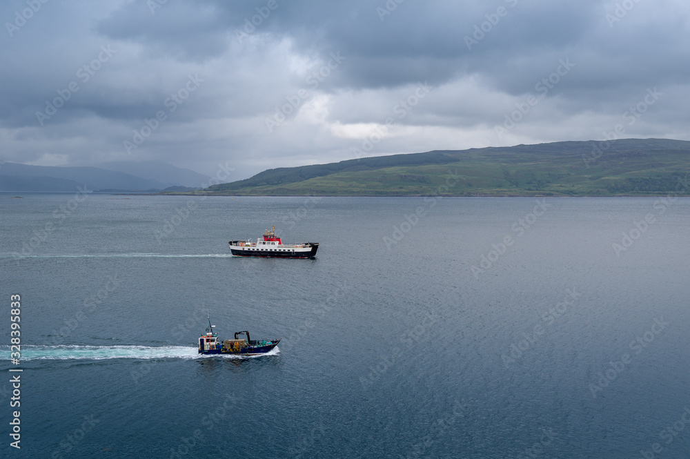 Small ferry and fishing vessel in scottish waters. Tobermory, Hebrides islands, Scotland. Small ferry and fishing vessel in scottish waters. Tobermory, Hebrides islands, Scotland.