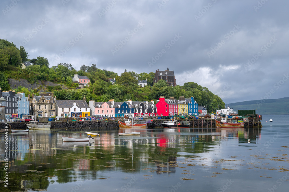 Tobermory embankment promenade after the rain. Nice old city, colorful boats and houses. Hebrides archipelago, Scotland.
