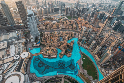 Aerial top view of Dubai famous fountains pool from above in morning from highest tower in world.