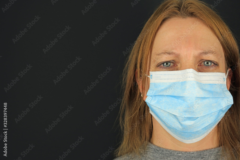 A Female With Watery Eyes Wearing A Surgical Mask. Coronavirus Outbreak Concept. A Female With Watery Eyes Wearing A Surgical Mask. Coronavirus Outbreak Concept.